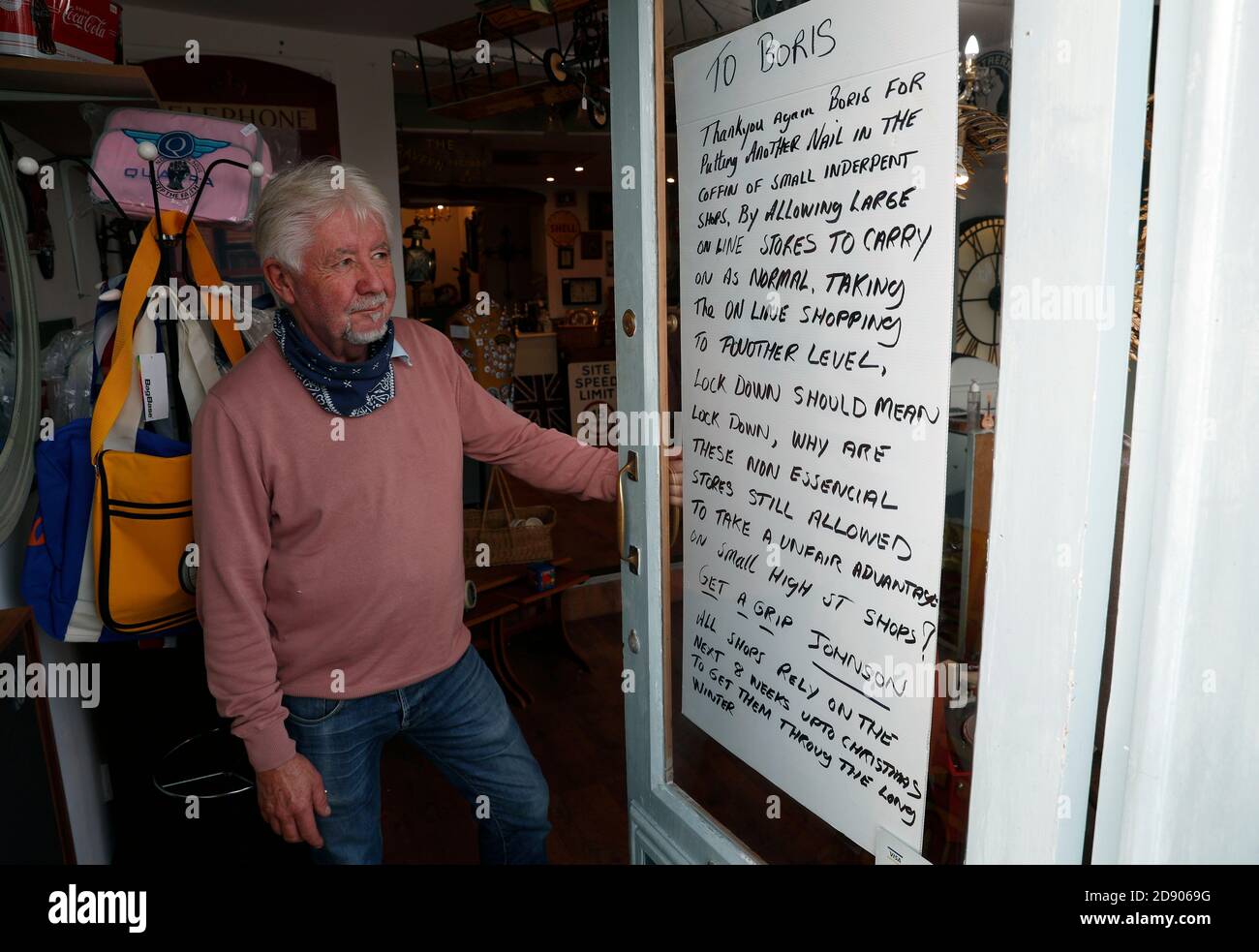 Loughborough, Leicestershire, UK. 2nd November 2020. Crazy DaisyÕs antique and collectables shop owner Rob Derrick stands next to his message to Prime Minister Boris Johnson after a second Covid-19 pandemic lockdown was announced. Credit Darren Staples/Alamy Live News. Stock Photo