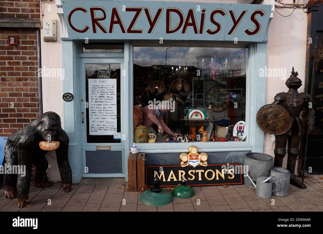 Loughborough, Leicestershire, UK. 2nd November 2020. Crazy DaisyÕs antique and collectables shop owner Rob Derrick works next to his message to Prime Minister Boris Johnson after a second Covid-19 pandemic lockdown was announced. Credit Darren Staples/Alamy Live News. Stock Photo