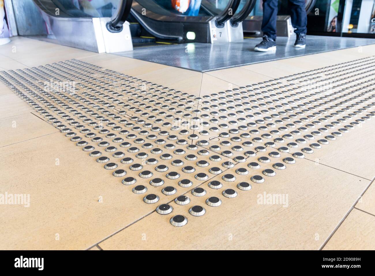 Metal floor tactile to guide vision impaired person at mall Stock Photo