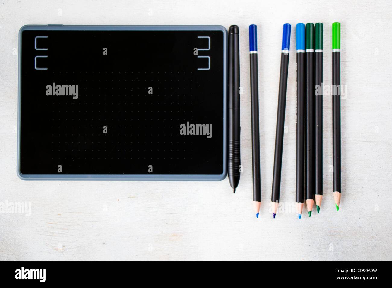 Drawing and painting tablet and styles pen and pencils on the white