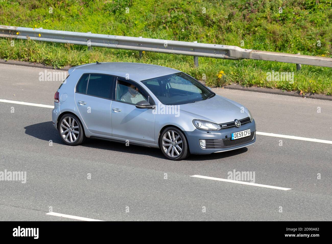 2009 silver Volkswagen Golf GTD S-A; Vehicular traffic, moving vehicles, cars, vehicle driving on UK roads, motors, motoring on the M6 motorway highway UK road network. Stock Photo