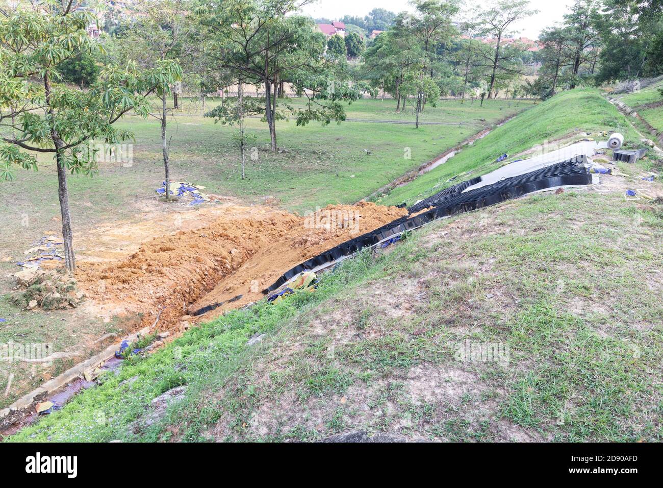 Slope erosion control grids, sheets and earth on steep slope Stock