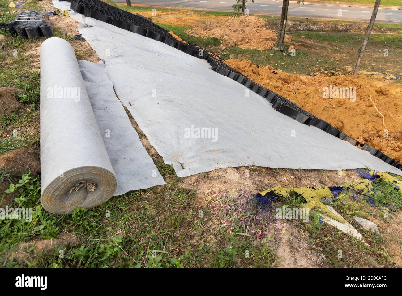 Slope erosion control grids, sheets and earth on steep slope Stock