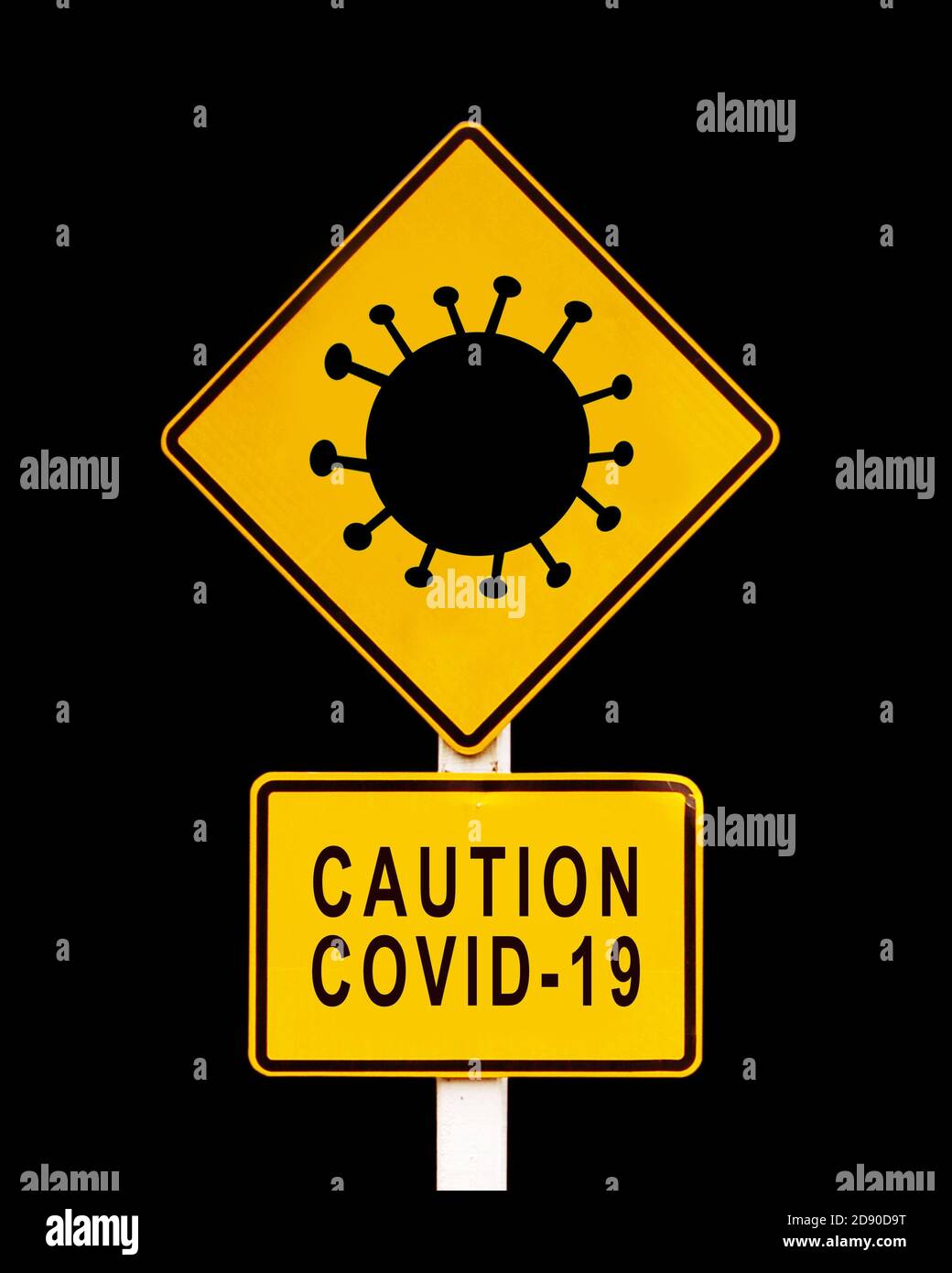 Caution Covid-19 written on a yellow warning danger roadsign. Coronavirus, covid pandemic concept Stock Photo