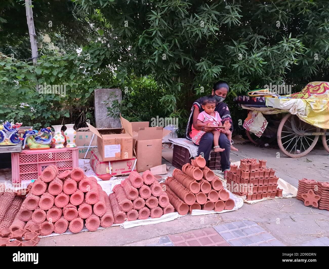 November 2, 2020, Poonch, Jammu and Kashmir, India: People buy mud lamps or diyas ahead of Diwali, the Hindu festival of lights on Monday 2nd November 2020, in Tirupati of Andhra Pradesh state, India.Potters are facing severe hardship due to Corona restrictions that has impacted buyers this year. (Credit Image: © Nazim Ali KhanZUMA Wire) Stock Photo