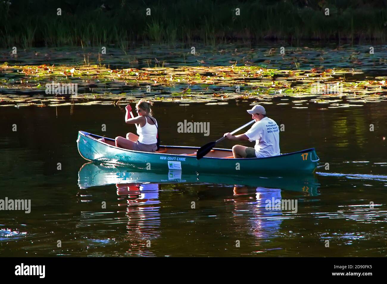 Couple canoe the Au Sable River for recreation and pleasure - Michigan Stock Photo