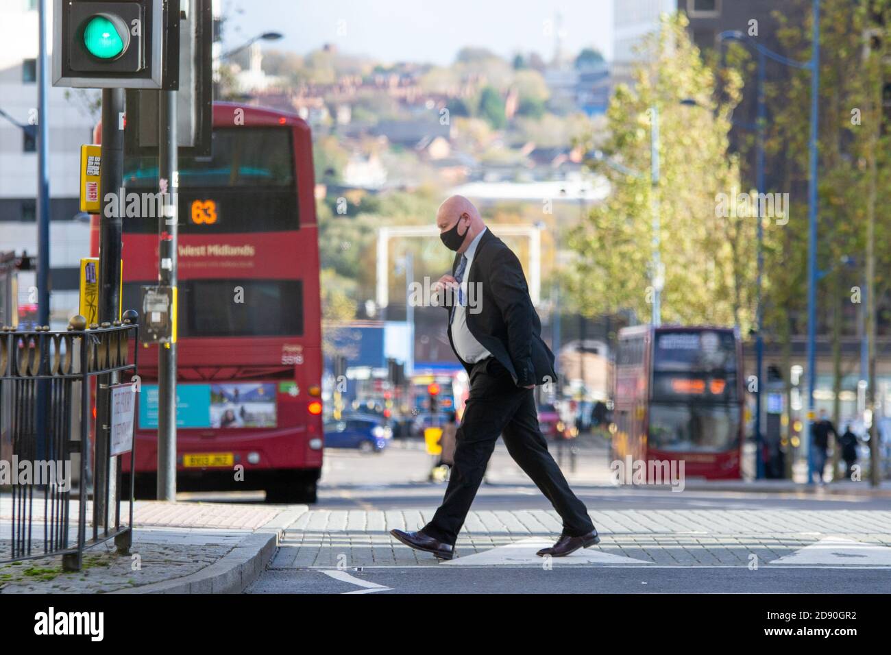 A masked gentleman in business attire in Birmingham city centre, as another national lockdown looms for November Stock Photo