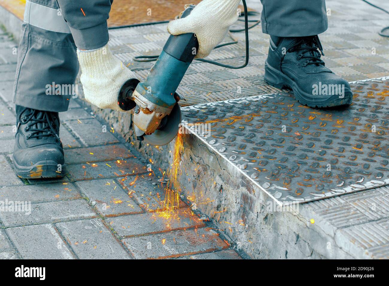 Processing of metal sheet with an angle-grinding tool Stock Photo