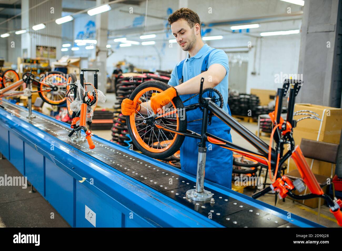 Bicycle factory, assembly line, wheel installation Stock Photo Alamy