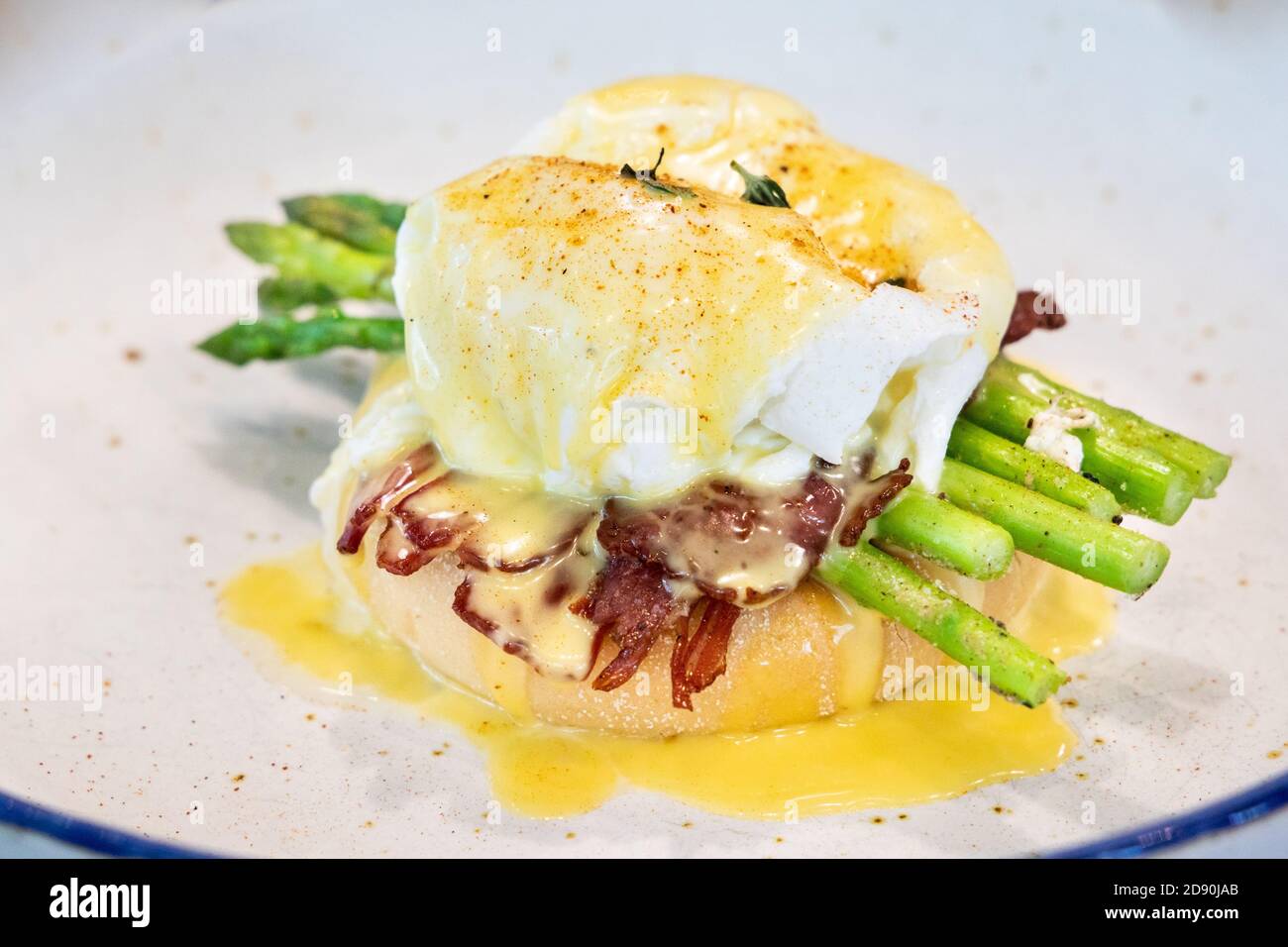 Serving of egg benedict with asparagus and bacon Stock Photo Alamy