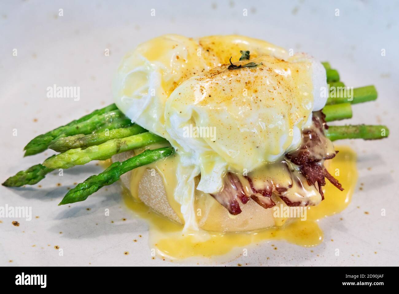 Serving of egg benedict with asparagus and bacon Stock Photo Alamy