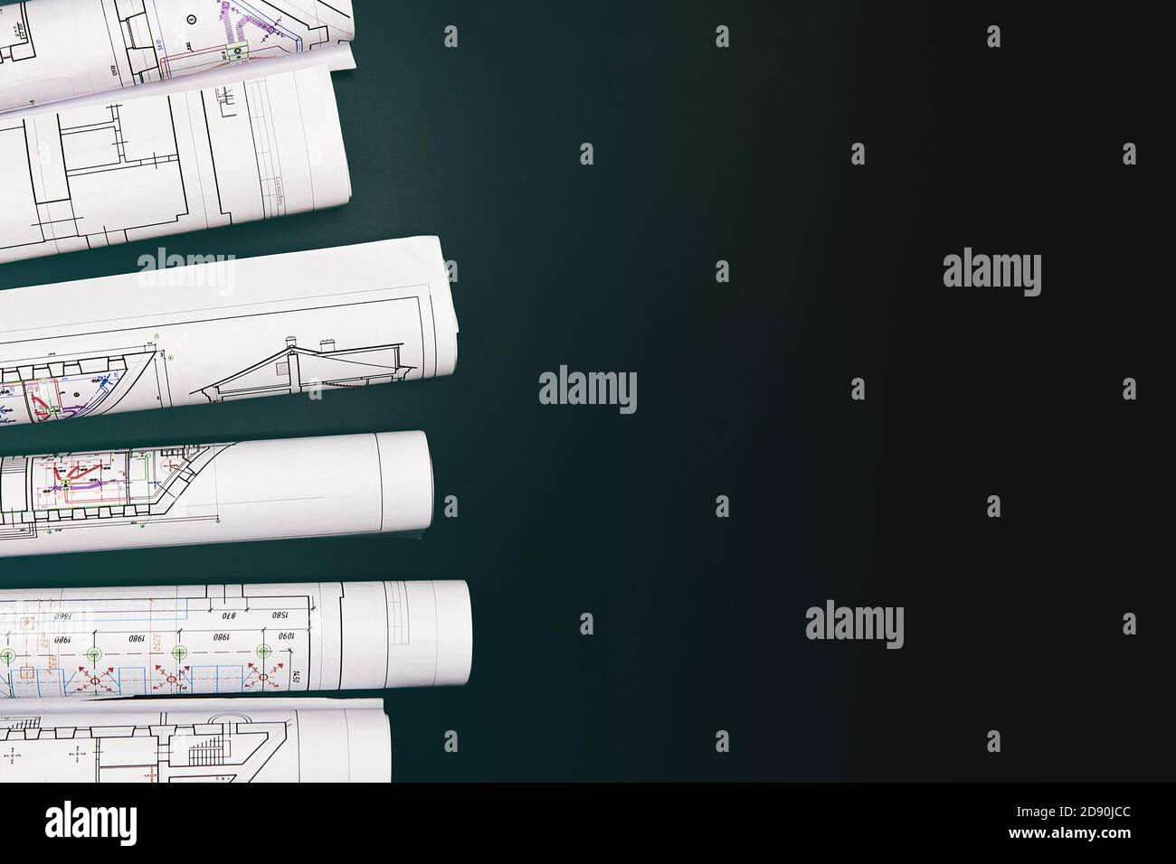 Architectural project, drawings on a dark background. Rolls of project drawings Stock Photo