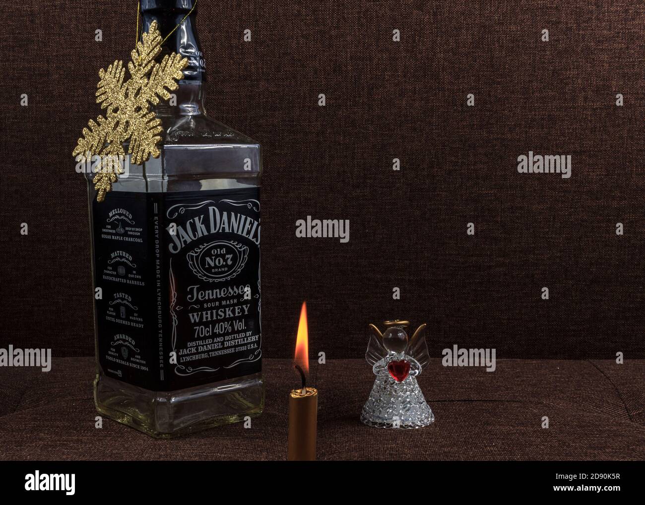 Christmas holiday concept, Jack Daniel bottle christmas tree creative, gold  shiny snowflake decoration on brown background Stock Photo - Alamy