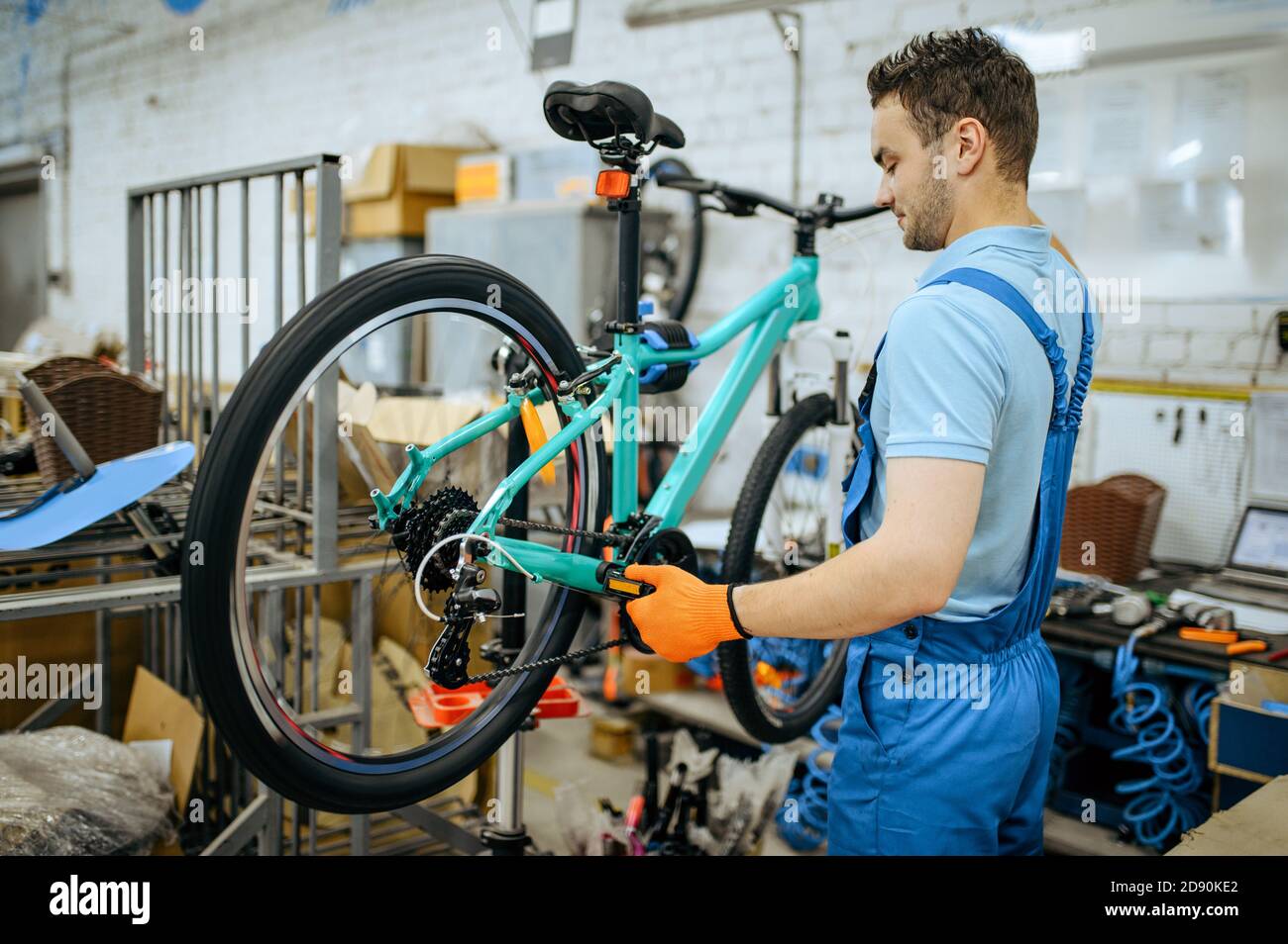 Bicycle factory, worker holds mountain bike Stock Photo Alamy
