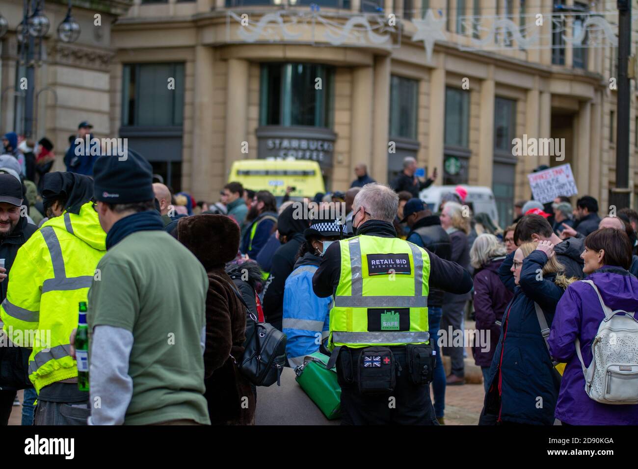 Retail BID officer amongst a crowd of anti-lockdown protester on Victoria Square, Birmingham Stock Photo