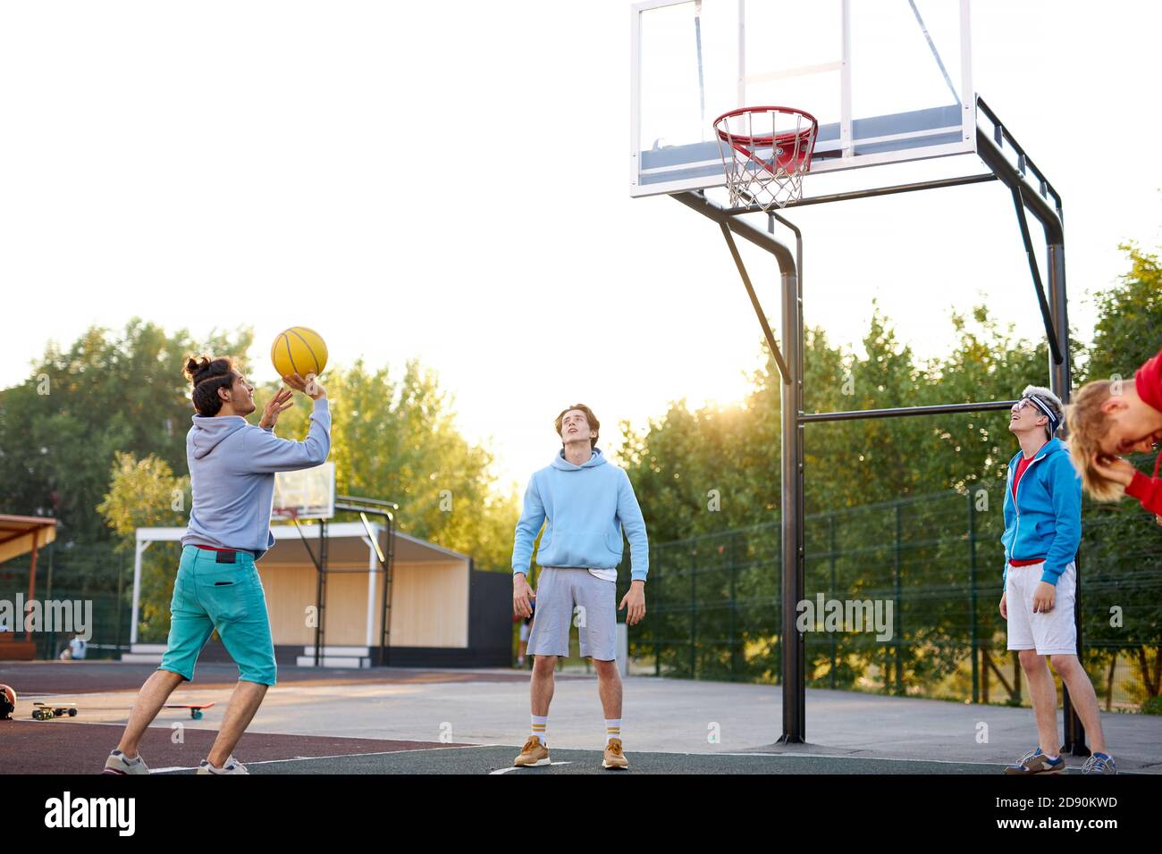 basketball players outdoors. summer vacation, holidays, games and