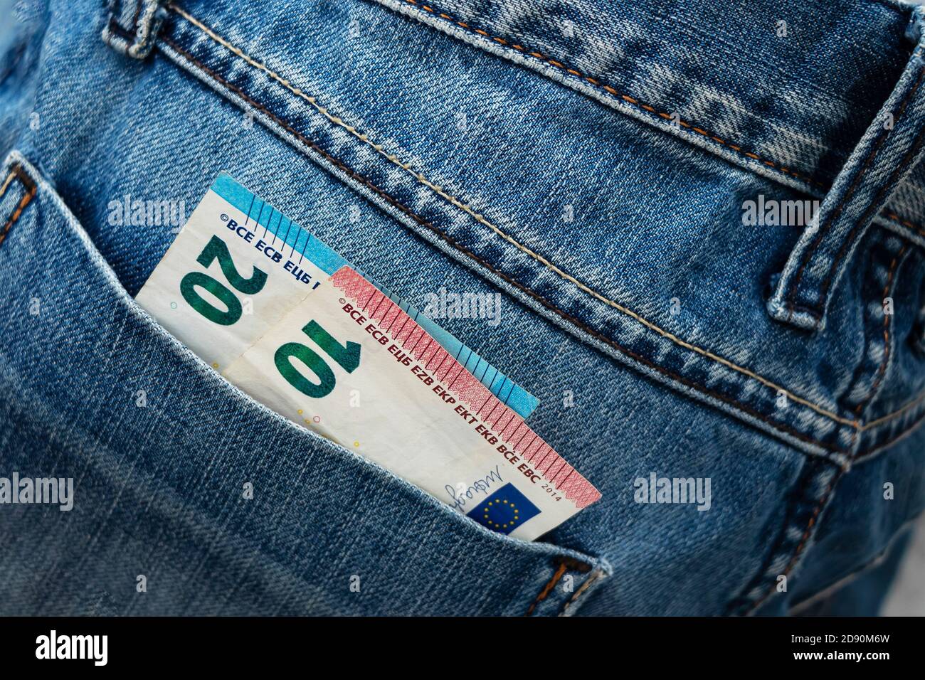 Euro bill in the back pocket of jeans. ThirtyEuro in a denim pocket. Close-up Stock Photo