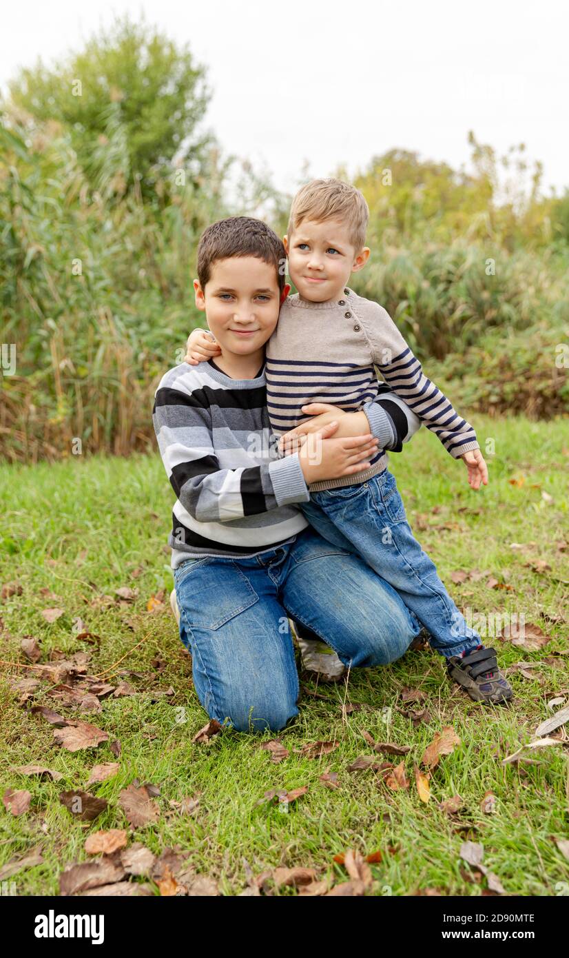 Two boys having fun together outdoor. Happy family. Brothers embracing  Stock Photo - Alamy