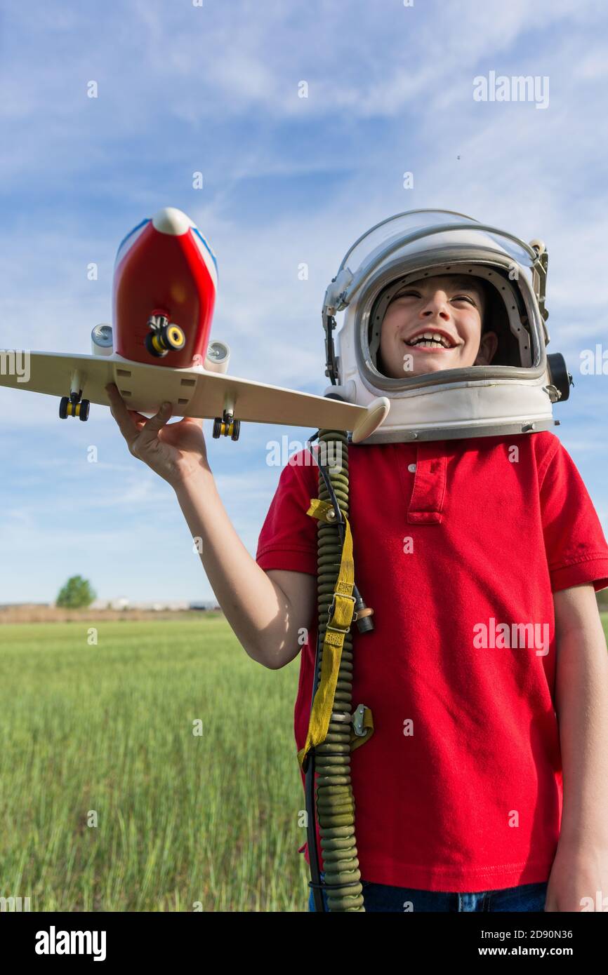 boy with astronaut helmet and plane, playing to be pilot Stock Photo ...