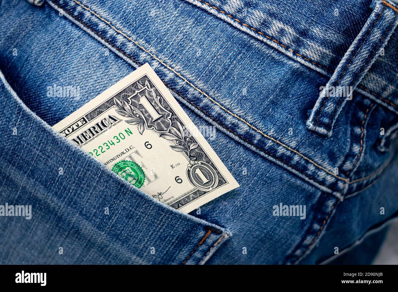 One Dollar bill in the back pocket of jeans. One buck in a denim pocket.  Close-up Stock Photo - Alamy
