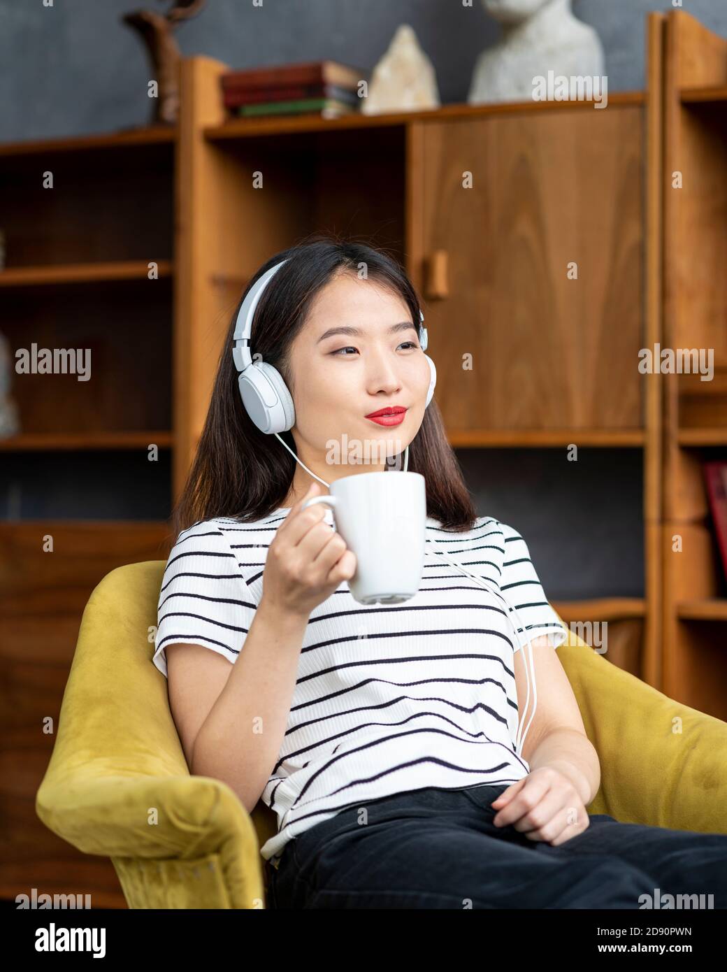 Girl listening music in chair hires stock photography and images Alamy