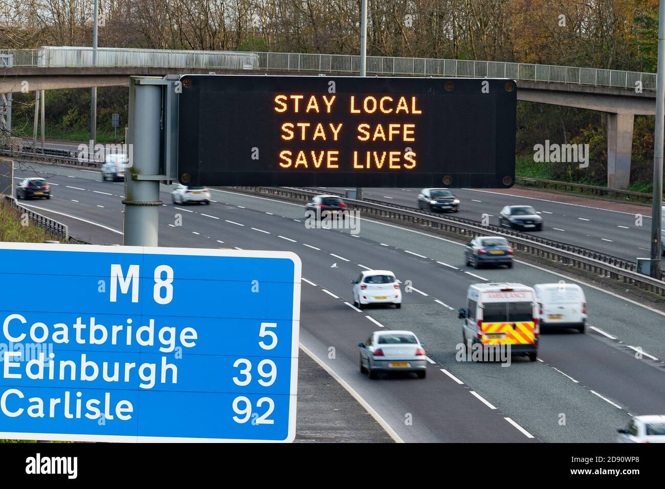 Glasgow,Scotland, UK. 2 November 2020. Motorists pass motorway gantry with Covid-19 health advisory message on the M8 in Glasgow as Scotland enters new Coronavirus lockdown regulations  with the central belt and Glasgow placed in Level 3. Iain Masterton/Alamy Live News Stock Photo
