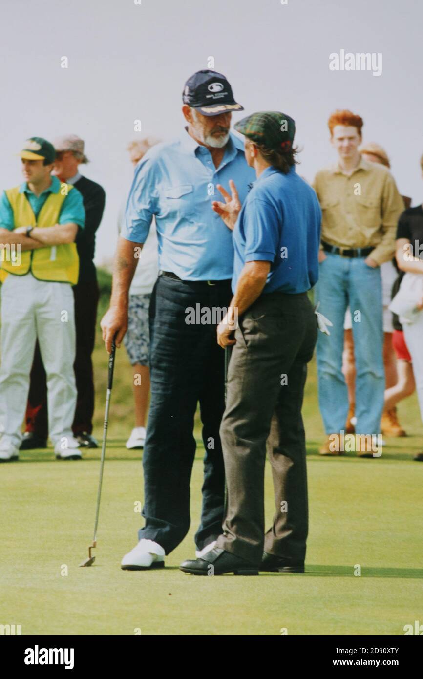 Prestwick, Ayrshire, Scotland, UK  :Late 1980s / early 1990's Sir Sean Connery talks to Sir Jackie Stewart at a Pro-am golf competiton held at Prestwick Old Course, the original course for the Open Golf championship Stock Photo
