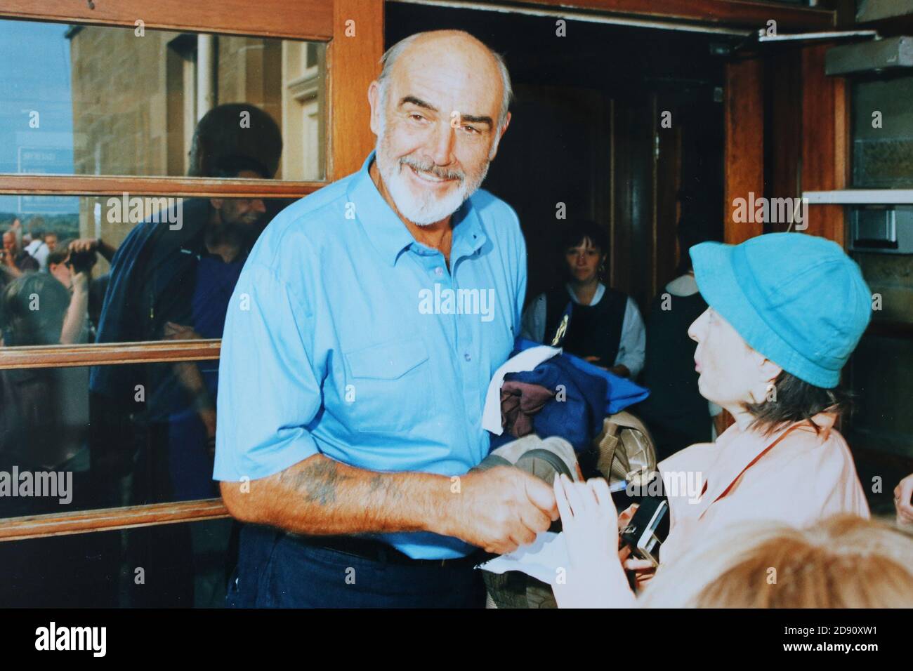 Prestwick, Ayrshire, Scotland, UK  :Late 1980s / early 1990's Sir Sean Connery signs an autograph at a Pro-am golf competiton held at Prestwick Old Course, the original course for the Open Golf championship Stock Photo