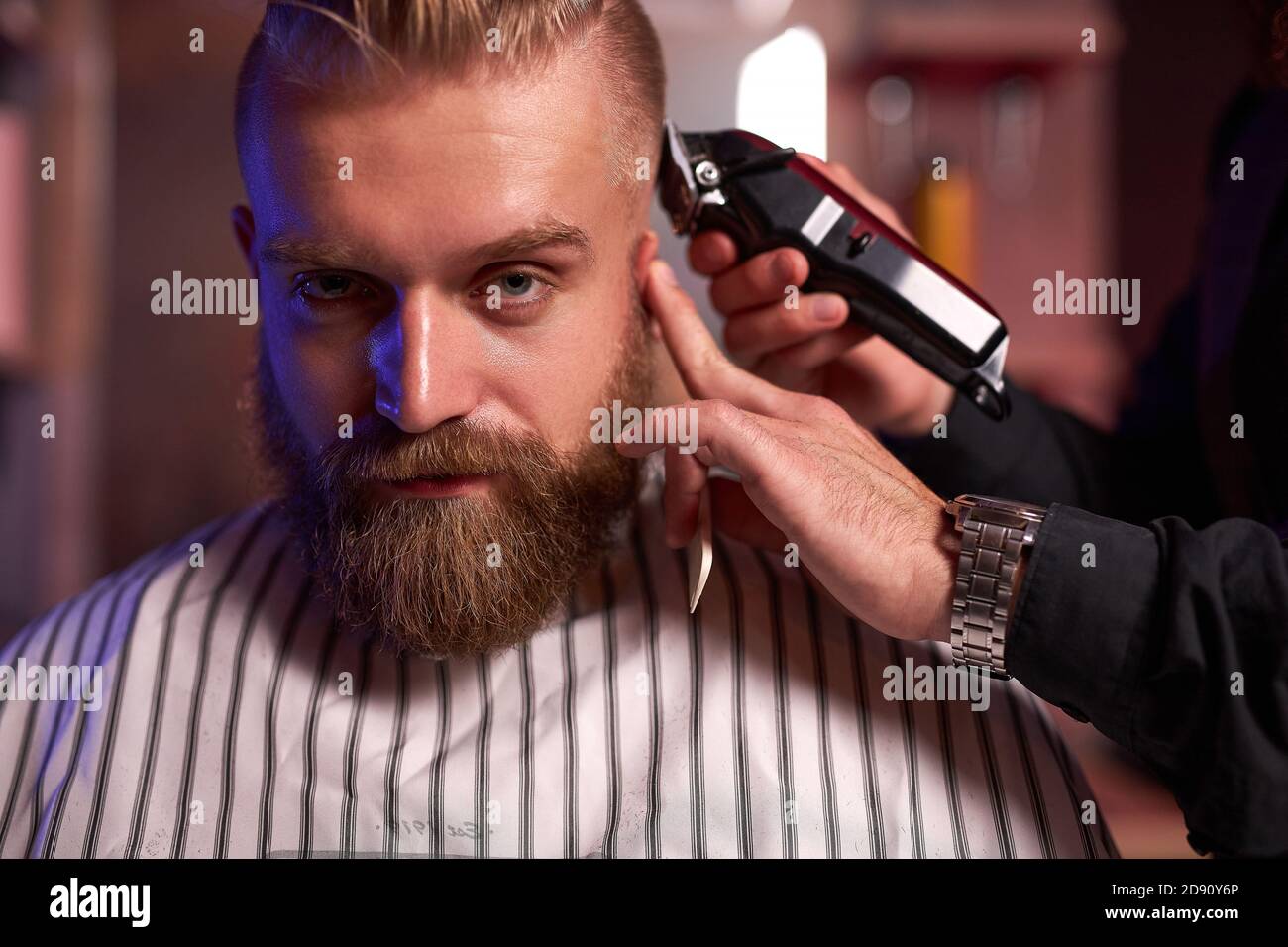 handsome caucasian man at the hairdresser in barber shop, barber male