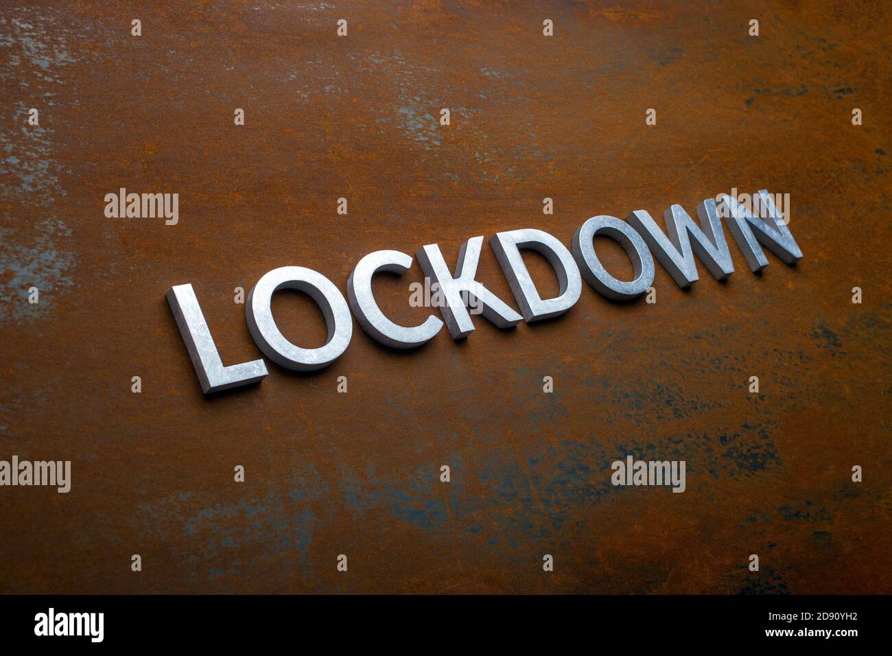the word lockdown laid with silver metal letters on flat rusted steel