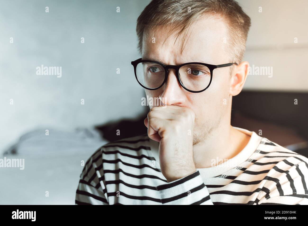Upset young man feeling melancholic sad suffering from seasonal