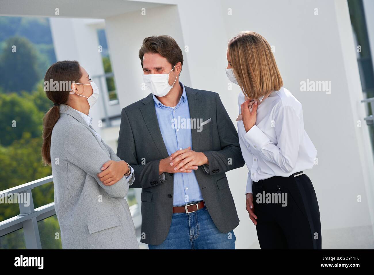 Team of businesspeople working in protective masks Stock Photo