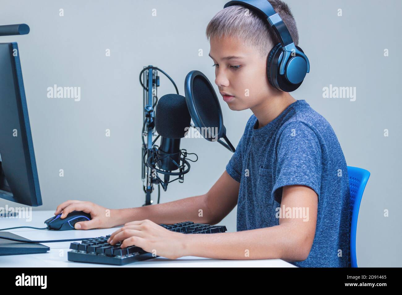 Teenager Boy Online Plays A Computer Game With Headphones And A