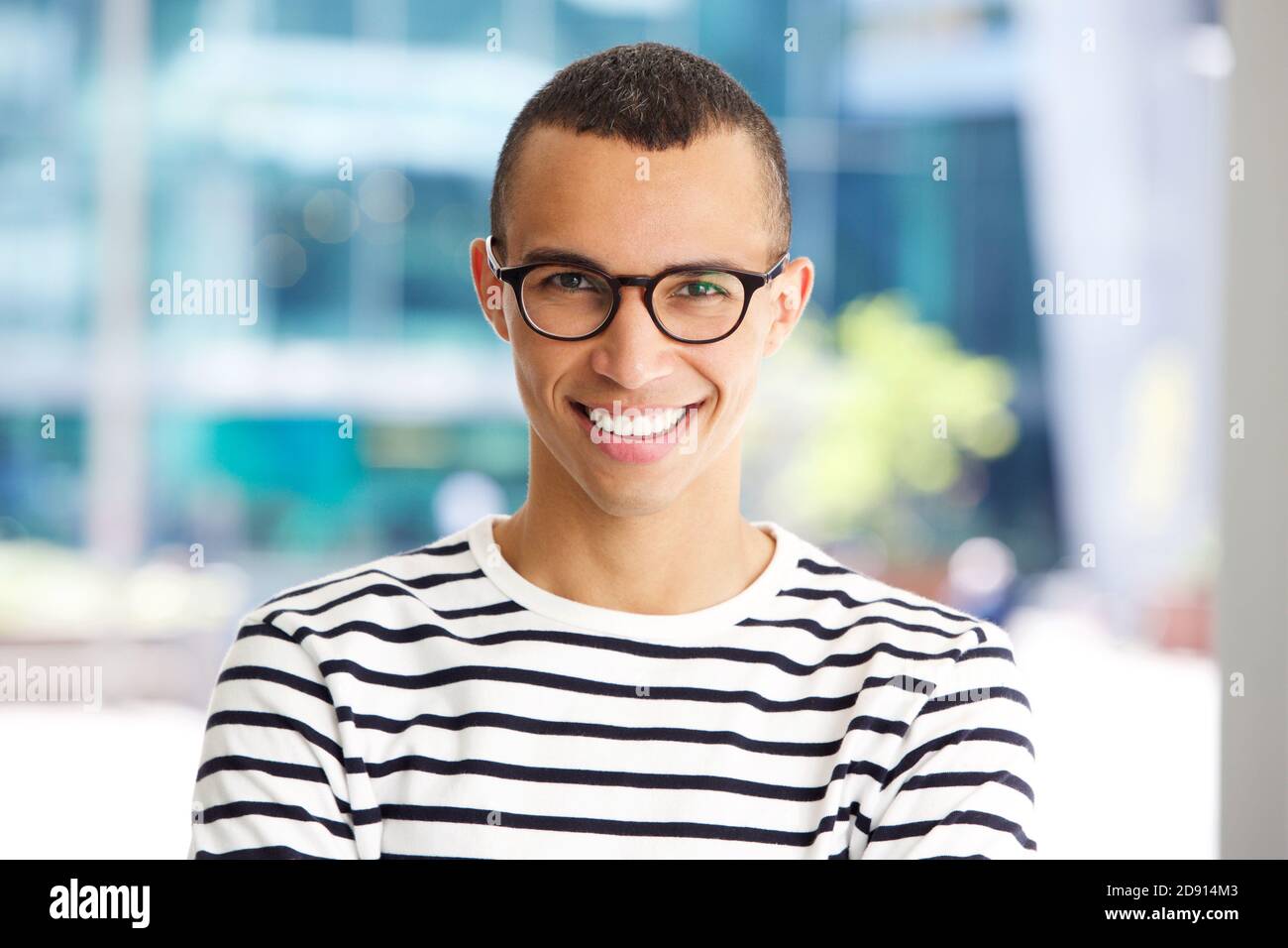 Close up horizontal portrait of handsome young man smiling with glasses ...