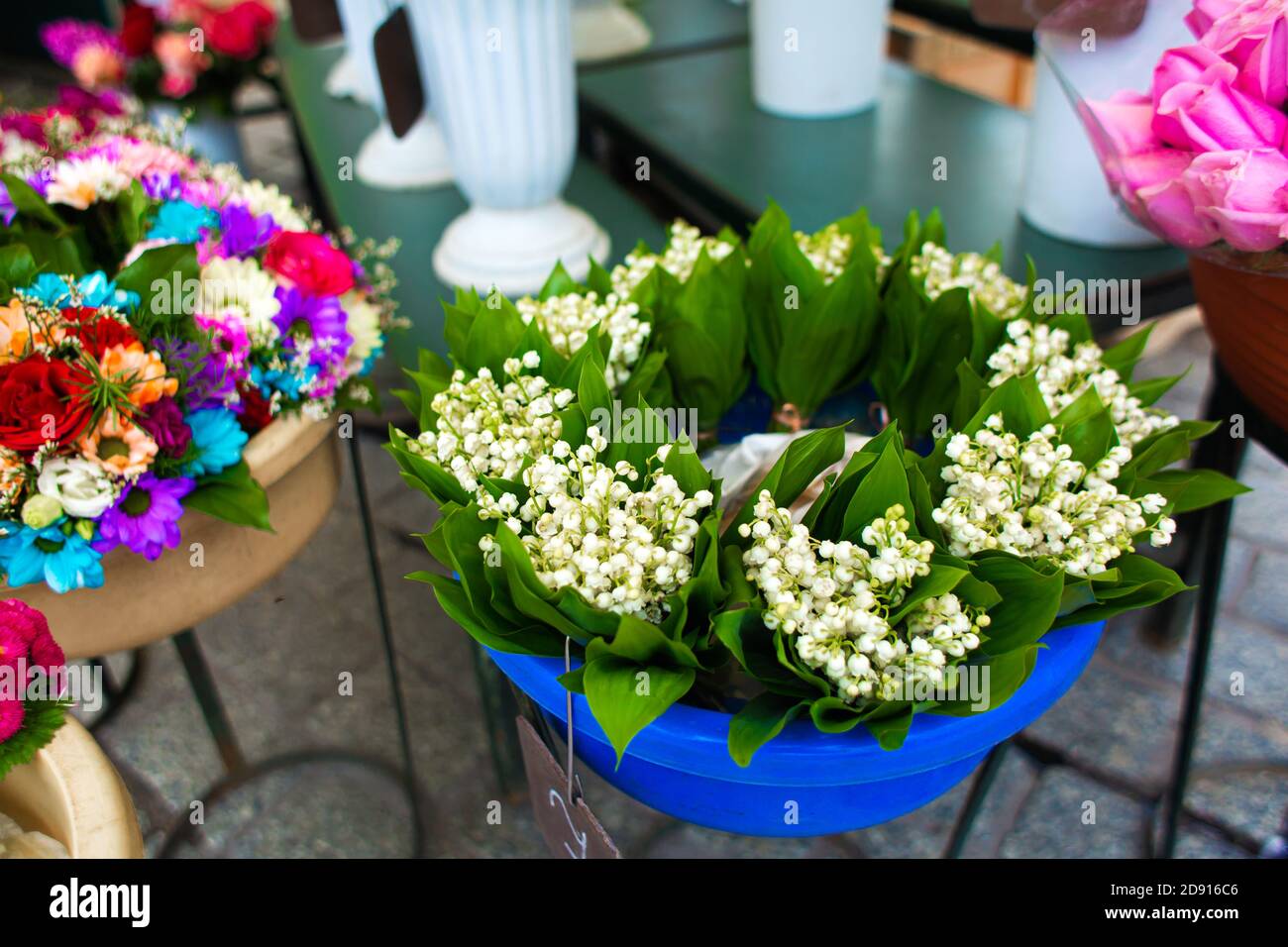 Street flower shop. Flowers in vases on the street. Stock Photo