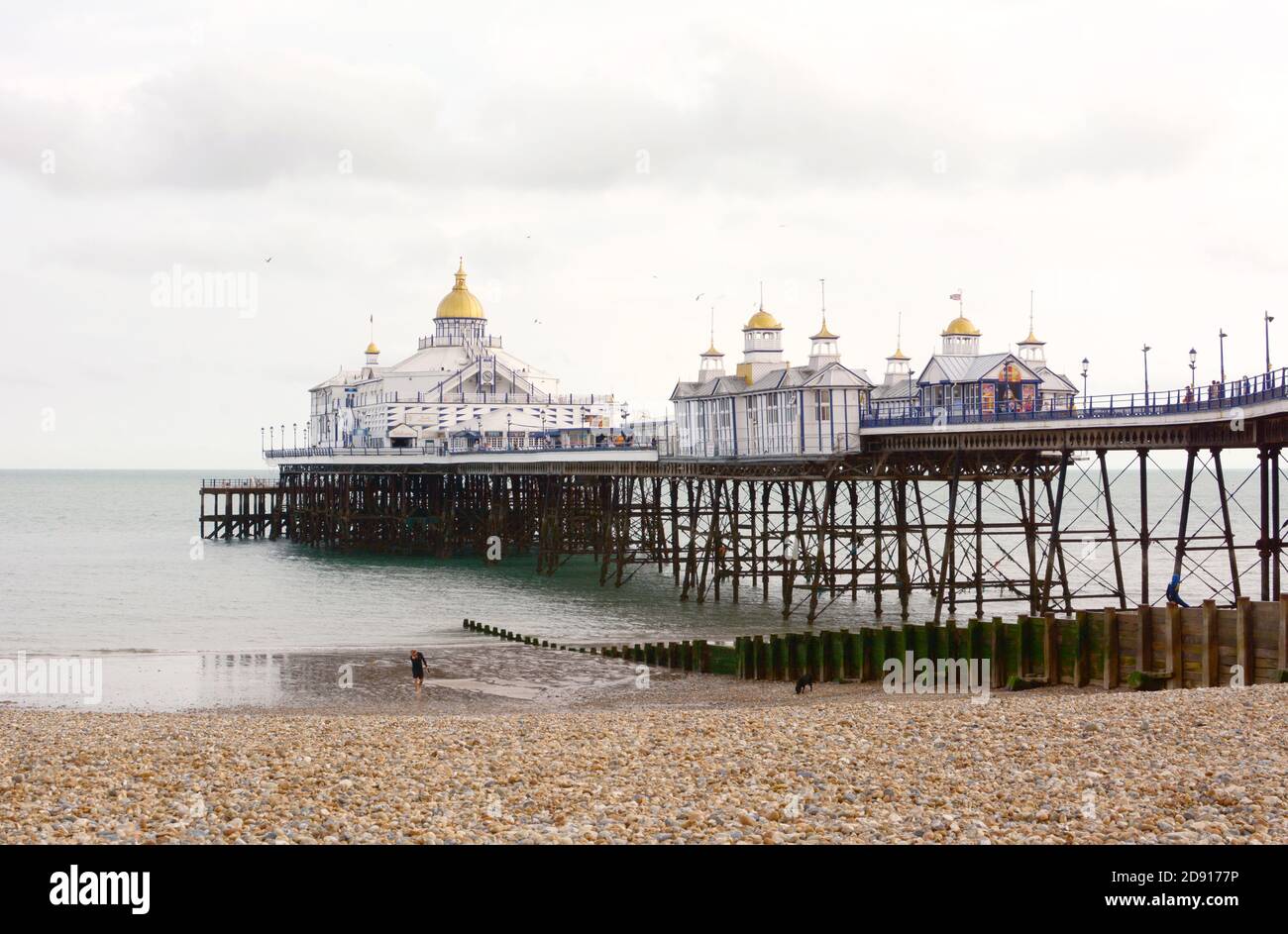 EASTBOURNE, UK - AUGUST 28, 2019: 300m long pleasure pier with gold-topped towers, built out into the sea in Eastbourne, UK on August 28, 2019 Stock Photo