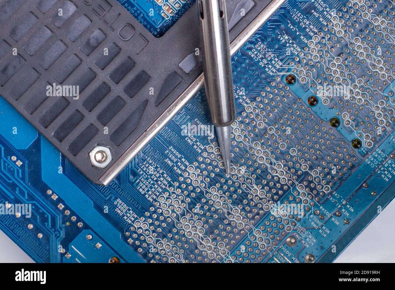 use a soldering iron to solder the electronic part to the Board. Computer repair. Macrophotography. Stock Photo