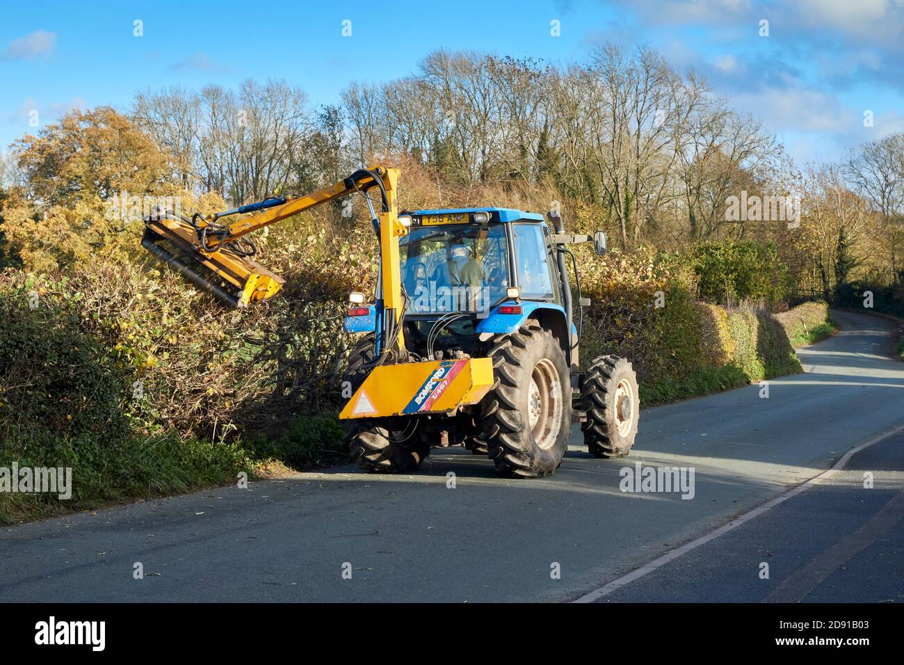 Hedge Cutting with a New Holland TS90 4WD Tractor and Bomford b467 flail mower Stock Photo