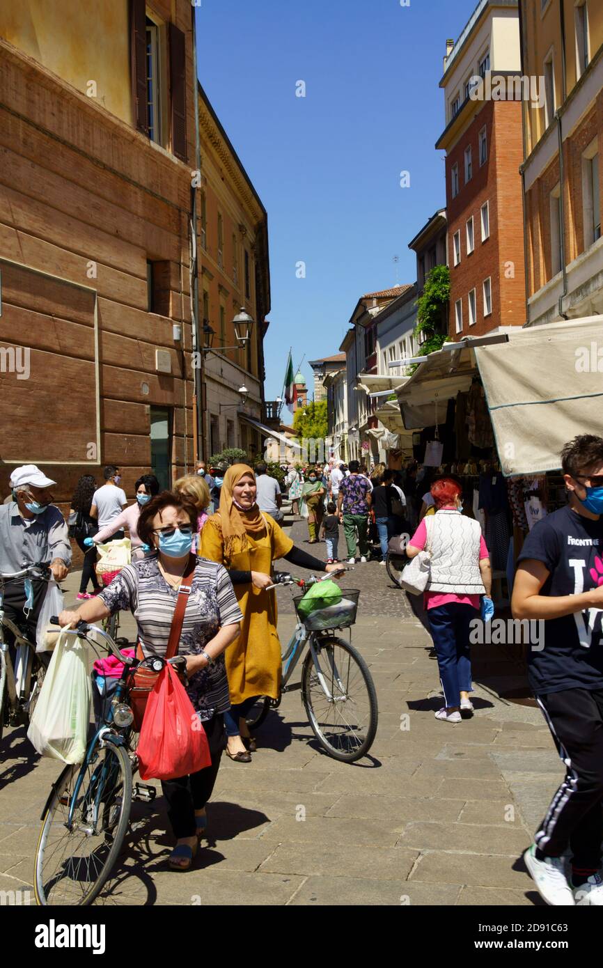 Forlì, Italy - June 01, 2020: Via delle Torri in downtown during a street market day. A lot of people around wearing protective face mask against coro Stock Photo