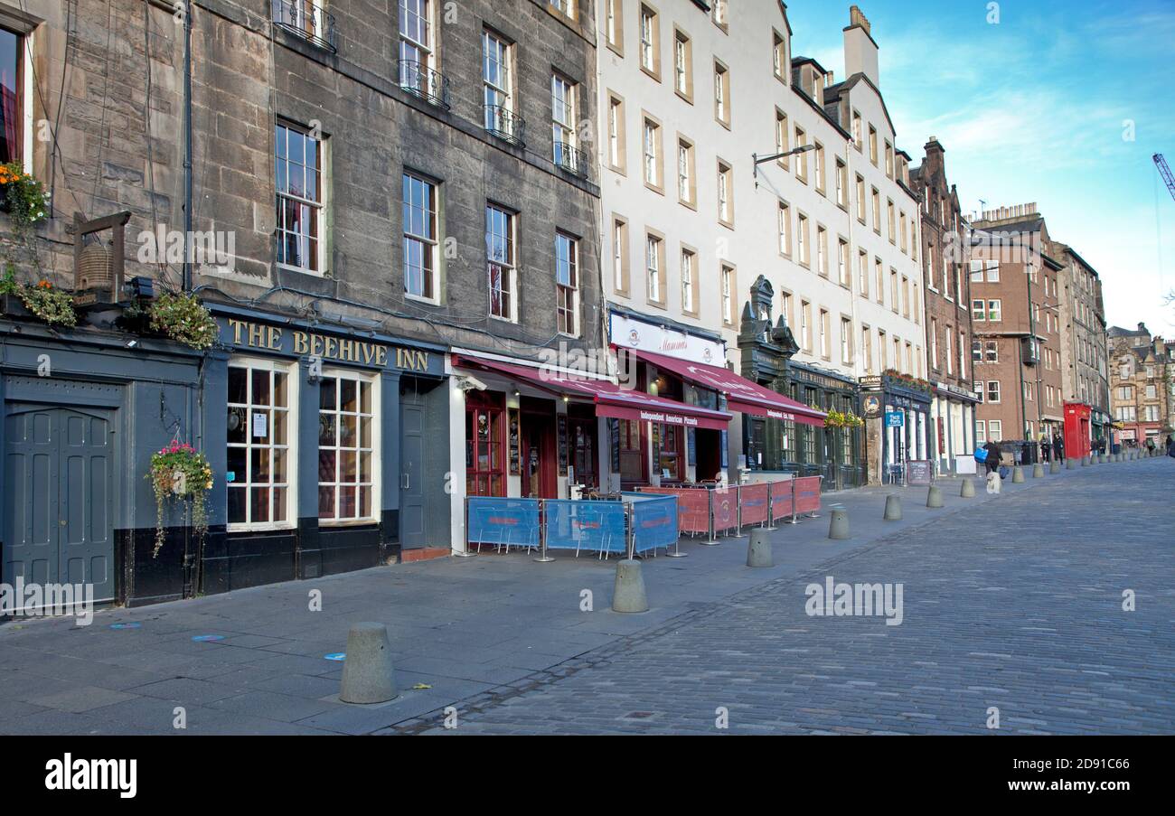 Edinburgh city centre, Scotland, UK. 2 November 2020. Edinburgh is now under Tier Three restrictions, the second highest alert level. In level three, hospitality premises will be allowed to open - but no alcohol can be sold, and they must close at 18:00. Although a few have opened, most establishments who normally sell alcohol and provide meals, have chosen not to open. Pictured: pubs in Grassmarket which have remained closed. Everywhere is quiet including cafes and tourist shops. Stock Photo