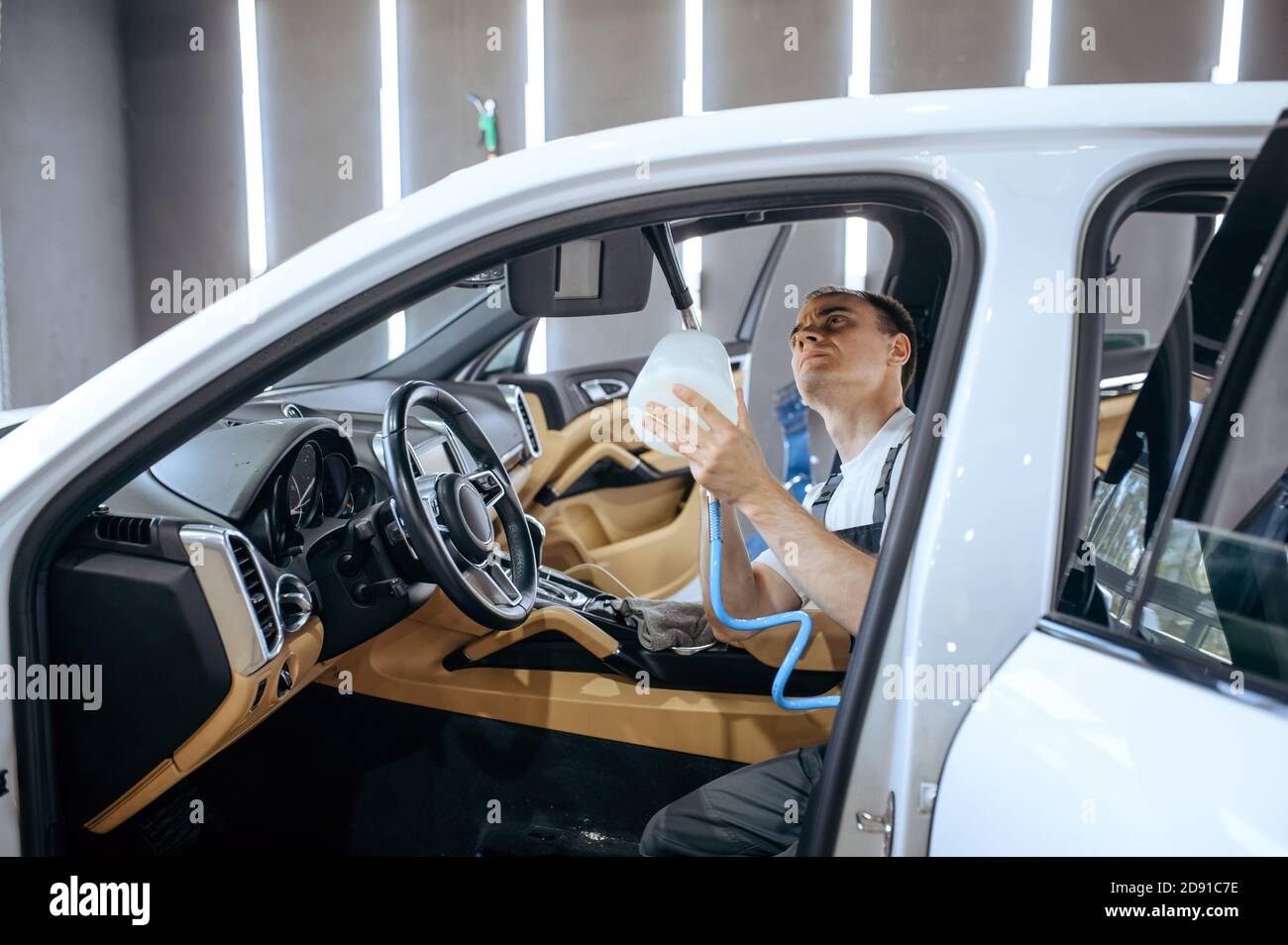 Worker watering car interior, detailing Stock Photo Alamy