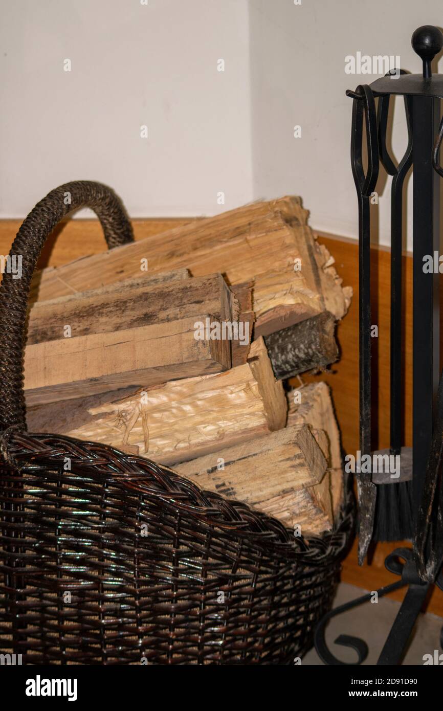 Fireplace basket full of wood at home Stock Photo Alamy