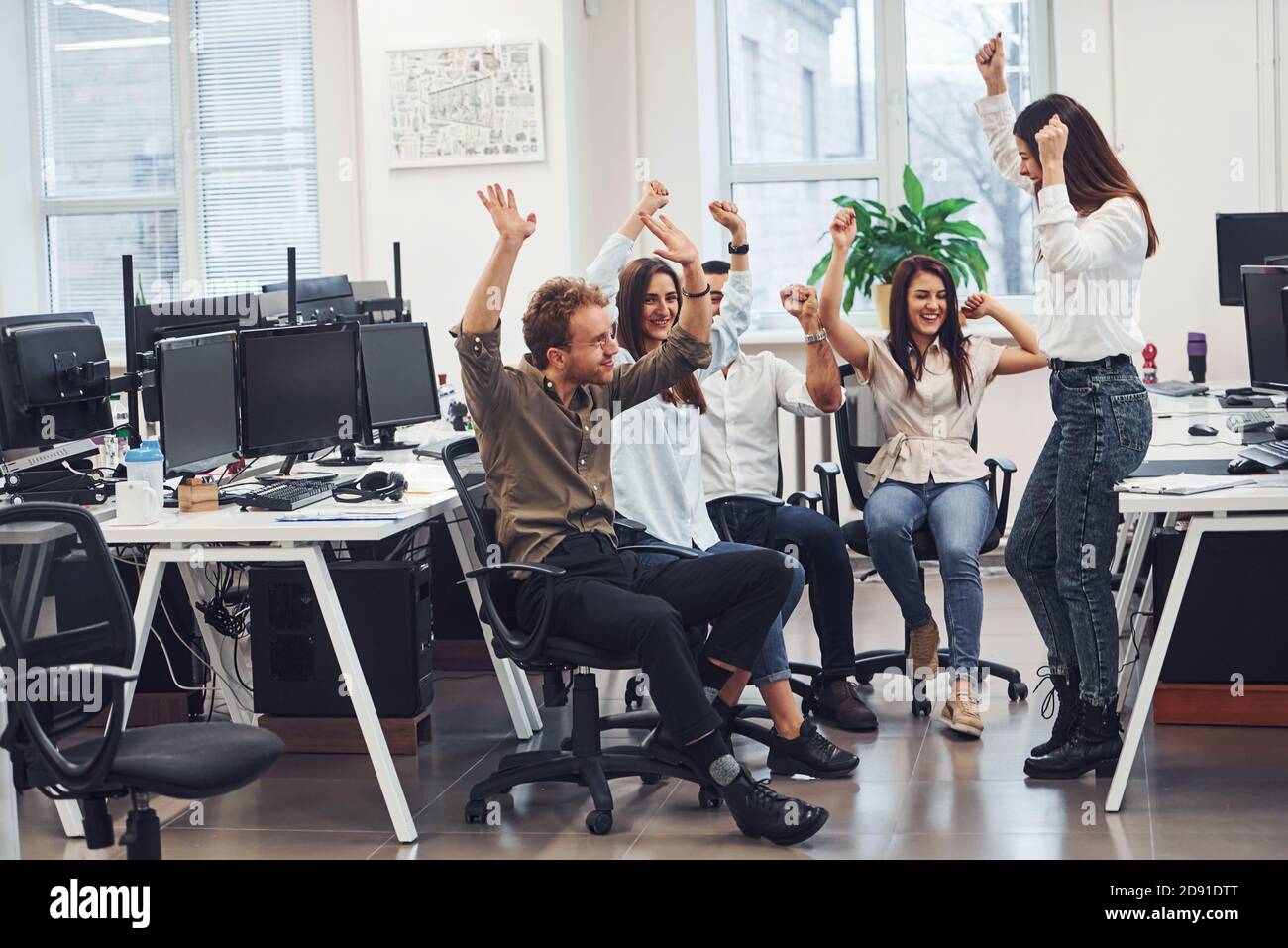 Young business people celebrating success in the modern office Stock ...