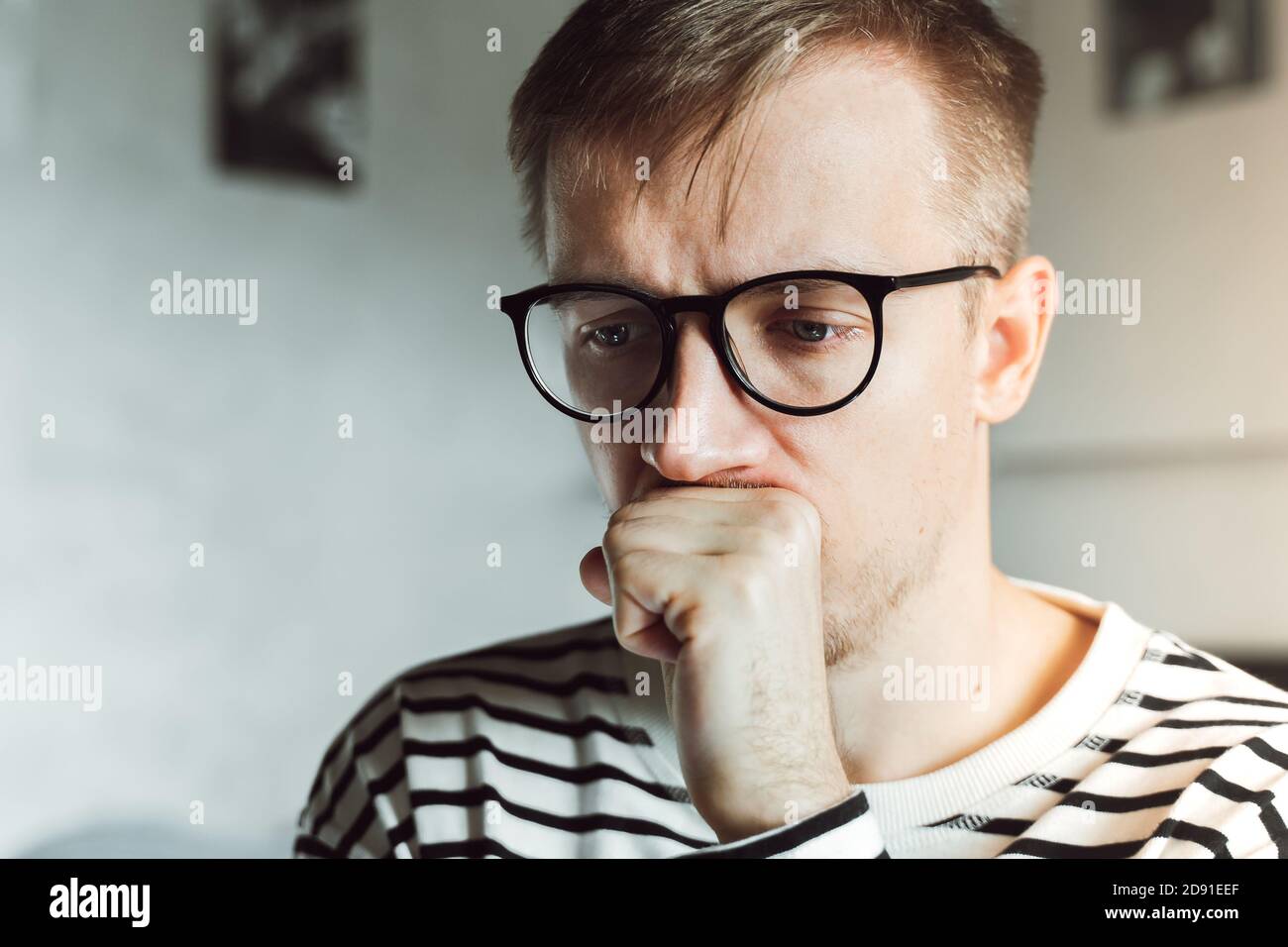 Upset young man feeling melancholic sad suffering from seasonal