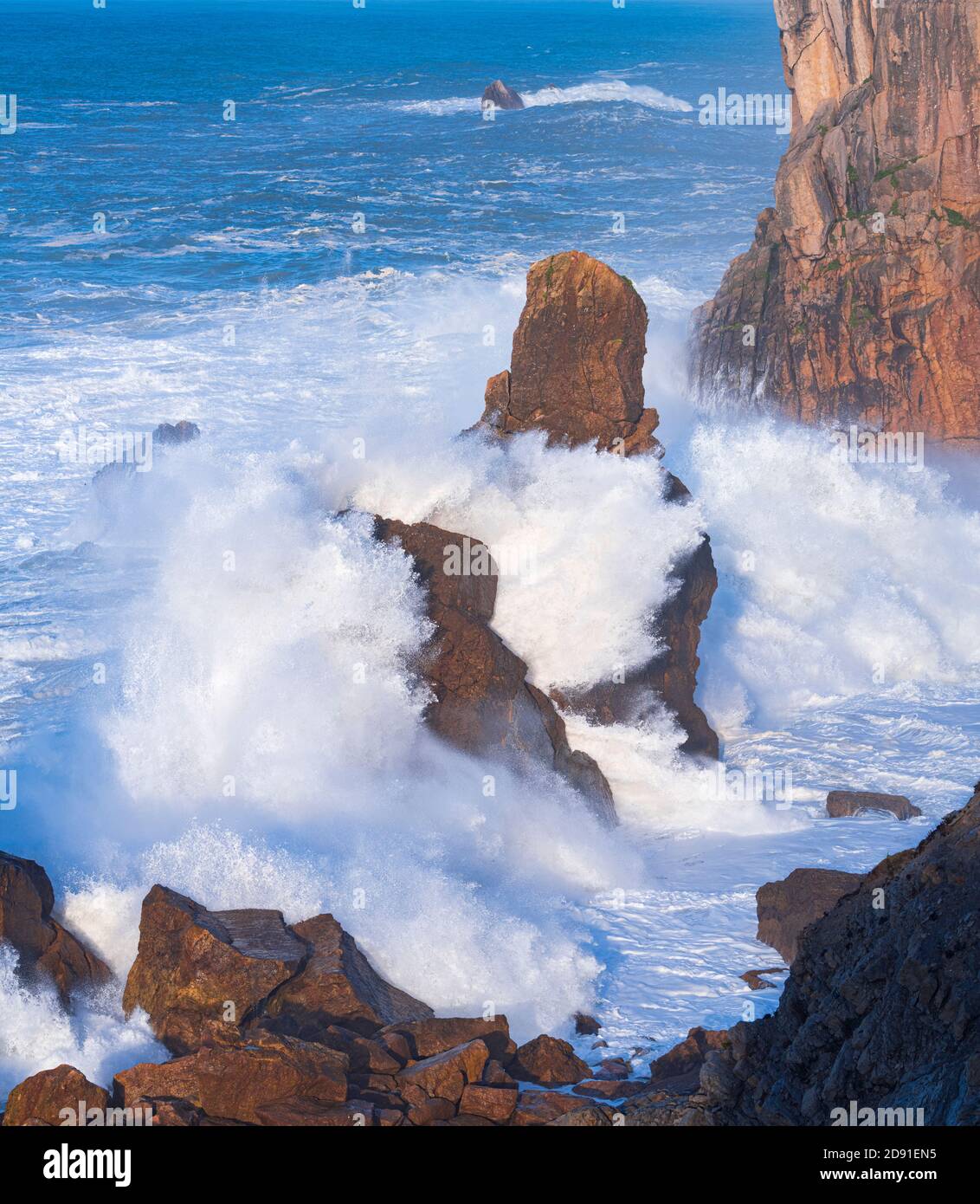 Dusk and waves in the Cantabrian Sea in the surroundings of Costa Quebrada in the Los Urros de Liencres area in the Municipality of Piélagos in the Au Stock Photo