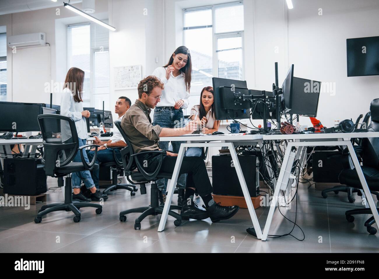 Group of young business people that working by computers in the modern ...