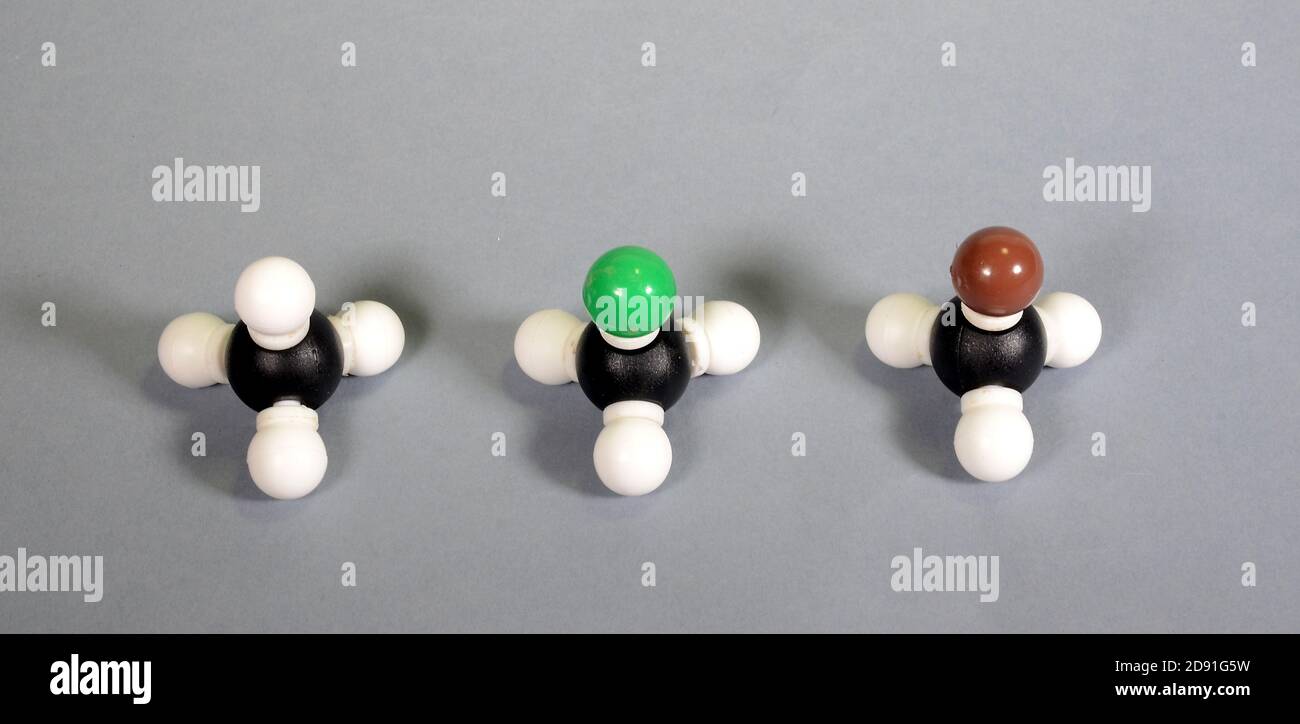 Three molecule models of methane two woith substitutions by halogens, from left: Nnormal methane, clormethane, and brom methane. Stock Photo