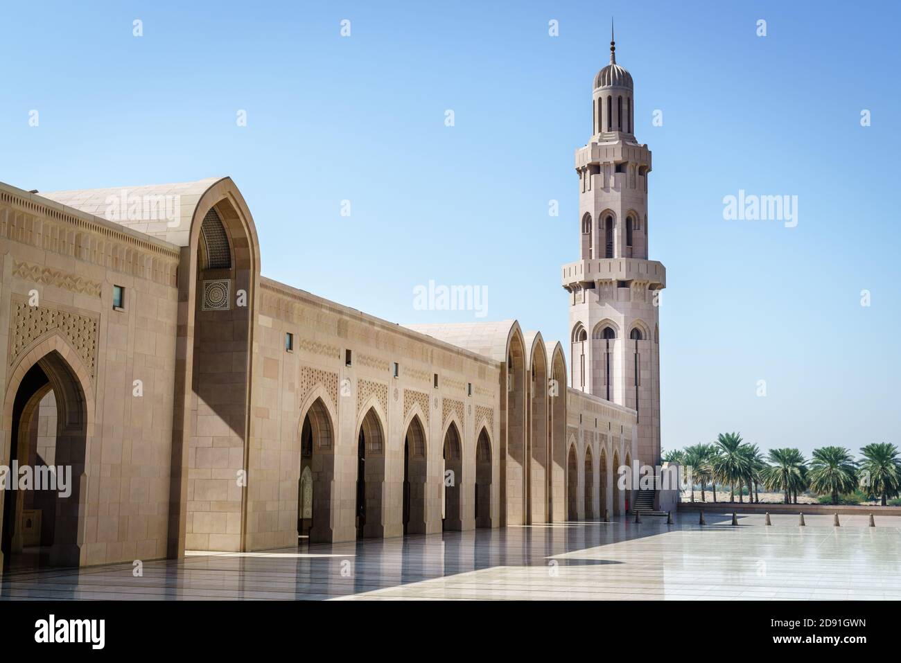 On of the minarets and a gallery at the Sultan Qaboos Grand Mosque in Muscat, Oman Stock Photo