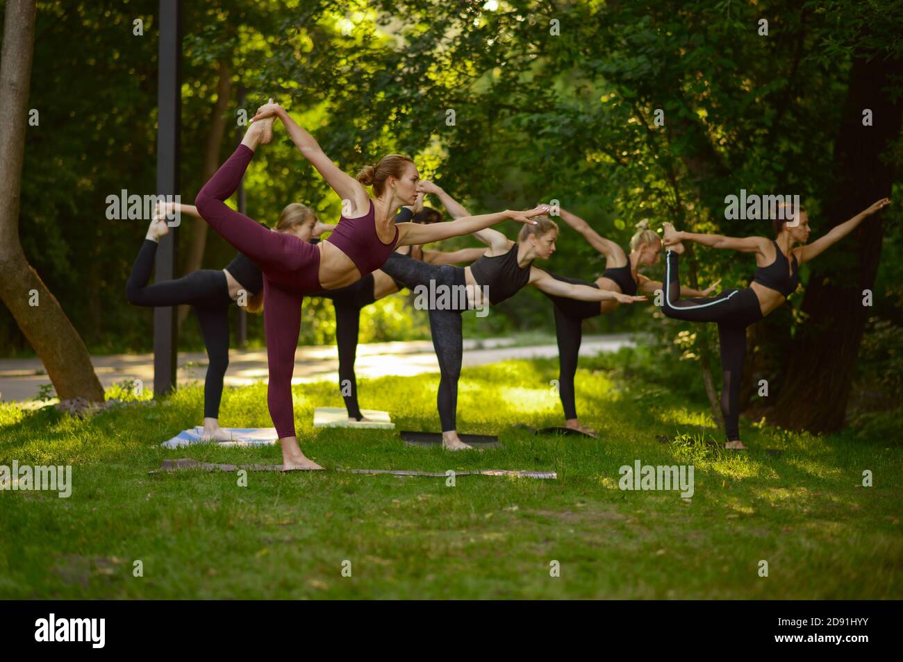 Women doing stretching exercise, group yoga Stock Photo