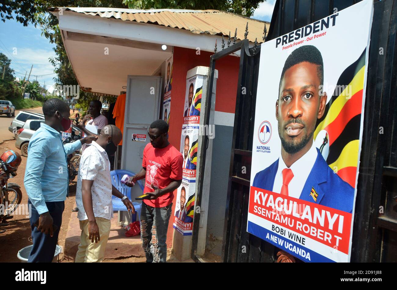 (Kampala, Uganda. 2nd Nov, 2020. A security guard checks people's body temperature at the entrance to the offices of opposition presidential candidate Robert Ssentamu Kyagulanyi, President of National Unity Platform (NUP), in Kampala, Uganda, Nov. 2, 2020. Uganda's electoral body on Monday started to nominate presidential candidates for 2021 general elections. Justice Simon Mugenyi Byabakama, chairperson of the Electoral Commission, said ten aspiring candidates have been verified and cleared for nominations in the two-day nomination exercise held at Kyambogo University Cricket Stock Photo